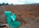 Field plot with flume and two tanks to catch runoff and transported sediments (© Christian Prat)